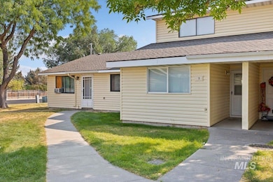 View of front of home featuring a shingled roof and a front yard