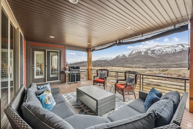 Deck with a grill, an outdoor living space, and a mountain view