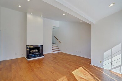 living room with gas fireplace and natural light l
