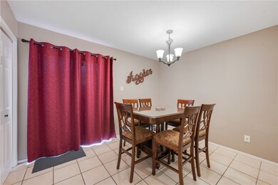 Dining room featuring a chandelier and light tile