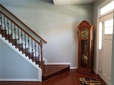 Foyer/Stairwell with iron balustrades leading to s