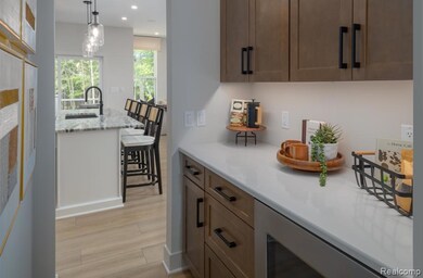 Bar featuring decorative light fixtures, light wood-style floors, recessed lighting, light stone countertops, and brown cabinetry