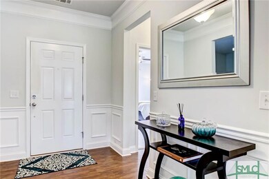 Formal foyer with crown molding, chair rail and wa