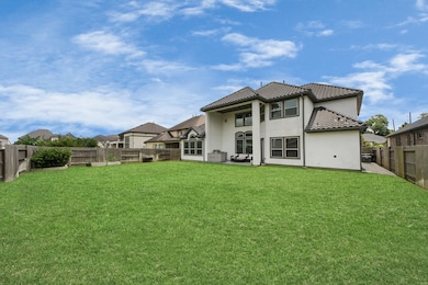 Large backyard with a spacious, covered patio and
