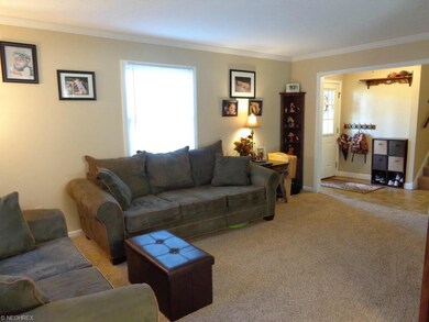 View #2 of the living room and front door foyer.