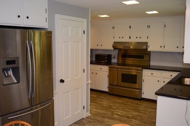 The stainless steel appliances, granite counterops