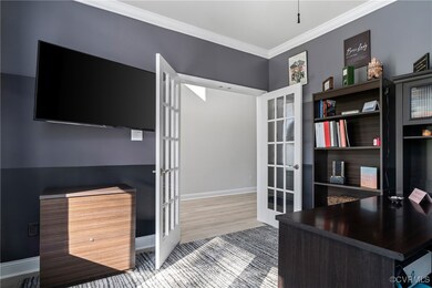 Office space with crown molding, french doors, and