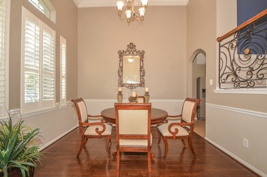 Tall ceilings and plantation shutters are an excellent accent to this formal dining room.