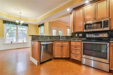 Kitchen opens to breakfast area and family room