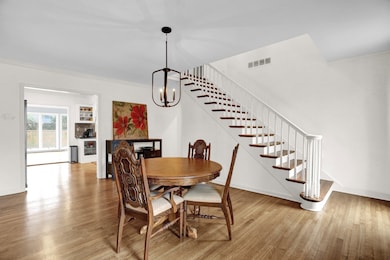 Dining area with crown molding, a chandelier, and 