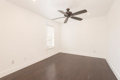 Empty room with dark wood-type flooring, recessed lighting, and ceiling fan