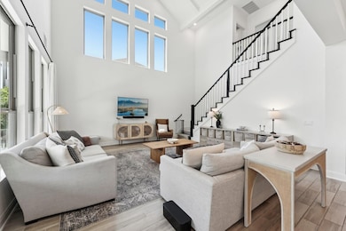 Living area featuring wood finished floors, stair
