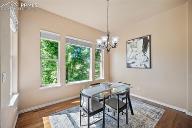 Dining room with a chandelier and dark wood-type flooring
