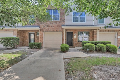 Charming townhouse with a brick exterior, featurin