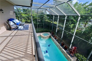 View of pool with a lanai and an in ground hot tub