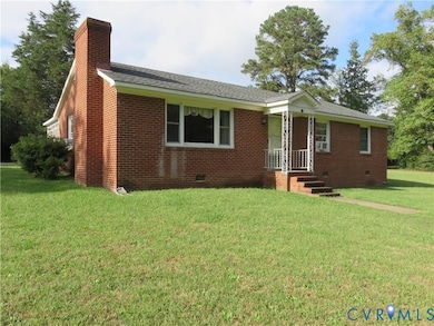 Ranch-style home featuring crawl space, a front yard, brick siding, a shingled roof, and a chimney