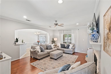Living area with a fireplace, crown molding, reces