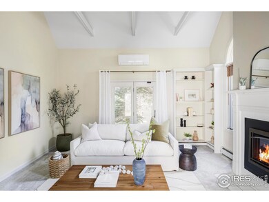 The main level flows beautifully between formal and informal living areas, including an airy living room with vaulted ceilings and fireplace, a dedicated dining room, and a cozy gathering room off the kitchen with oversized windows and a second fireplace.