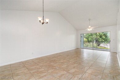 Spare room with a chandelier, a ceiling fan, high