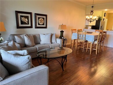 Living room with a notable chandelier, dark hardwo