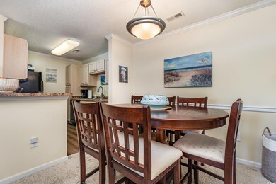 Dining space with crown molding, sink, light carpe