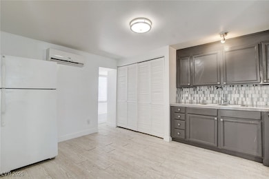 Kitchen with freestanding refrigerator, a wall uni