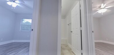 Hall with light wood-type flooring and baseboards