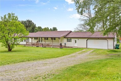 Ranch-style house featuring a garage, a front lawn, and a porch