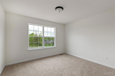 Spare room with carpet floors and baseboards