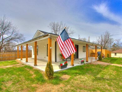 View of front of property with a patio area, a front yard, and fence
