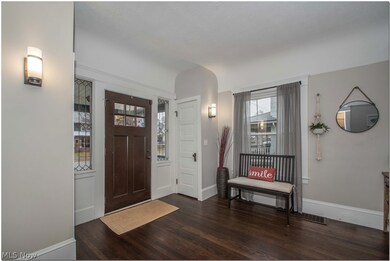 Entry way welcomes you with original century old hardwood flooring.  Cove ceilings, and an abundance of character.