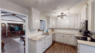 Updated kitchen with stone countertops and stainle