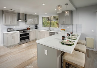 The cook in the family will appreciate the bright and spacious remodeled kitchen with its sparkling picture window, shaker cabinetry, self-closing doors/drawers, pots and pans drawers, walk-in pantry, quartz countertops, custom subway tiled backsplas