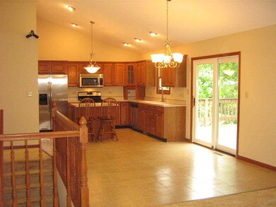 Ceramic tile kitchen floor has sliding doors to wo