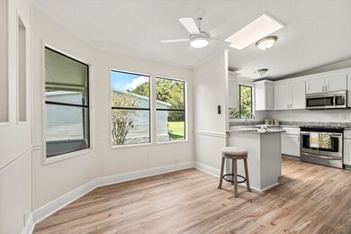 Kitchen Nook into Newly Appointed Kitchen w/Granite Counter Tops and Stainless Appliances.Skylight in Kitchen
