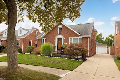 View of front of property featuring garage and a front lawn