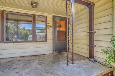 View of exterior entry featuring covered porch