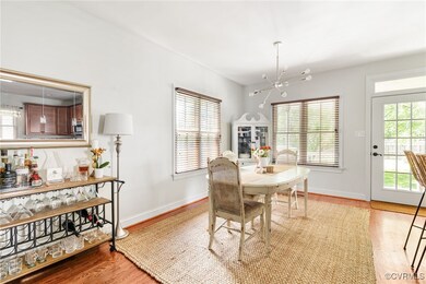 Living area with wood finished floors and crown mo