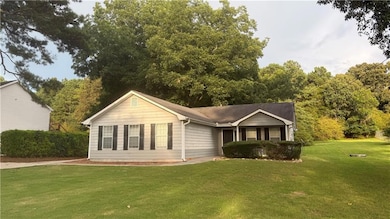 Ranch-style house featuring a front lawn