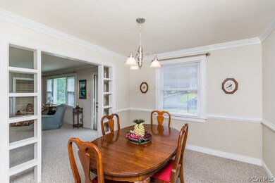 A comfortable and open dining room with both crown and chair rail molding.