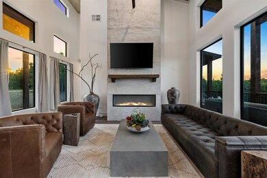Living room with a large fireplace and a towering 