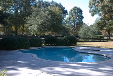 pool and deck looking out to the pasture