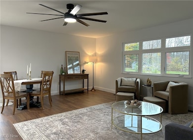 Spacious Living Room with newer picture window, ceiling fan and flooring.