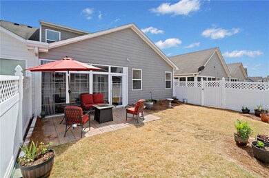 Back of house with a fenced backyard, an outdoor f