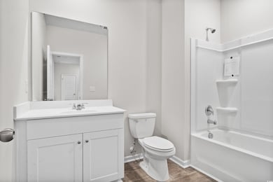 Full bathroom featuring hardwood / wood-style floo