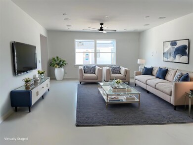 Living room featuring a ceiling fan, finished con