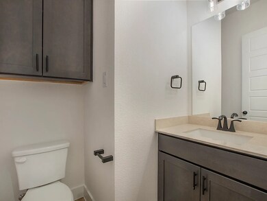 Convenient half bath with modern vanity — ideal for guests.