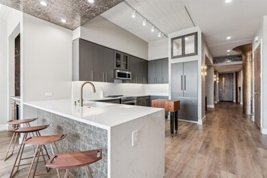Kitchen featuring gray cabinetry, light hardwood /