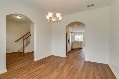 DINING AREA LOOKING TOWARD OPEN KITCHEN
