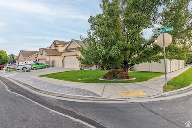 View of front facade featuring concrete driveway, stucco siding, and an attached garage